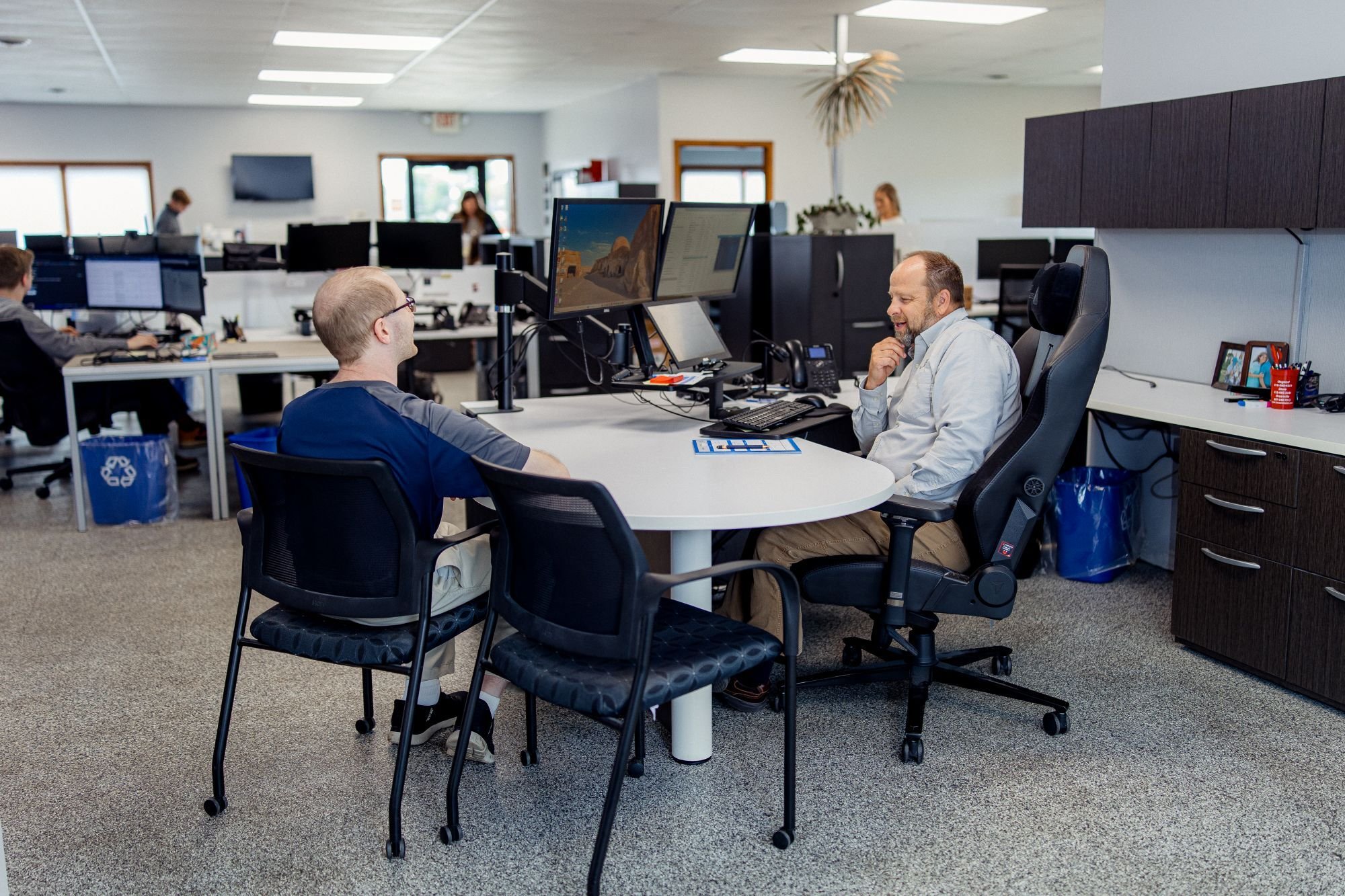 employees discussing at desk
