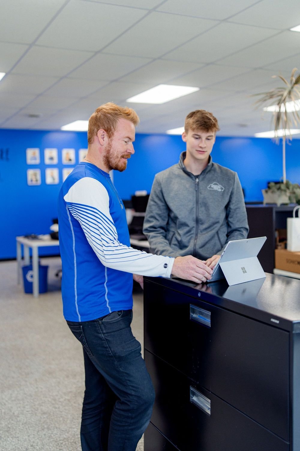 two men working on laptop
